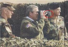 Mr. Bush pretending to use the binoculars